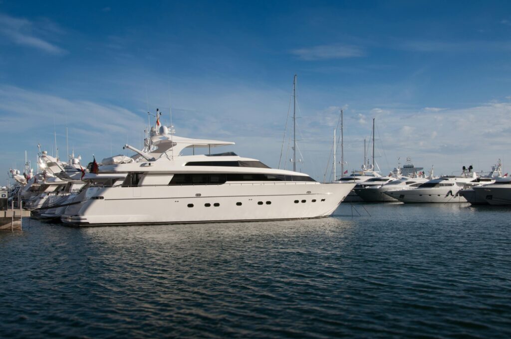 a serene marina scene featuring luxury yachts docked under a clear blue sky.
