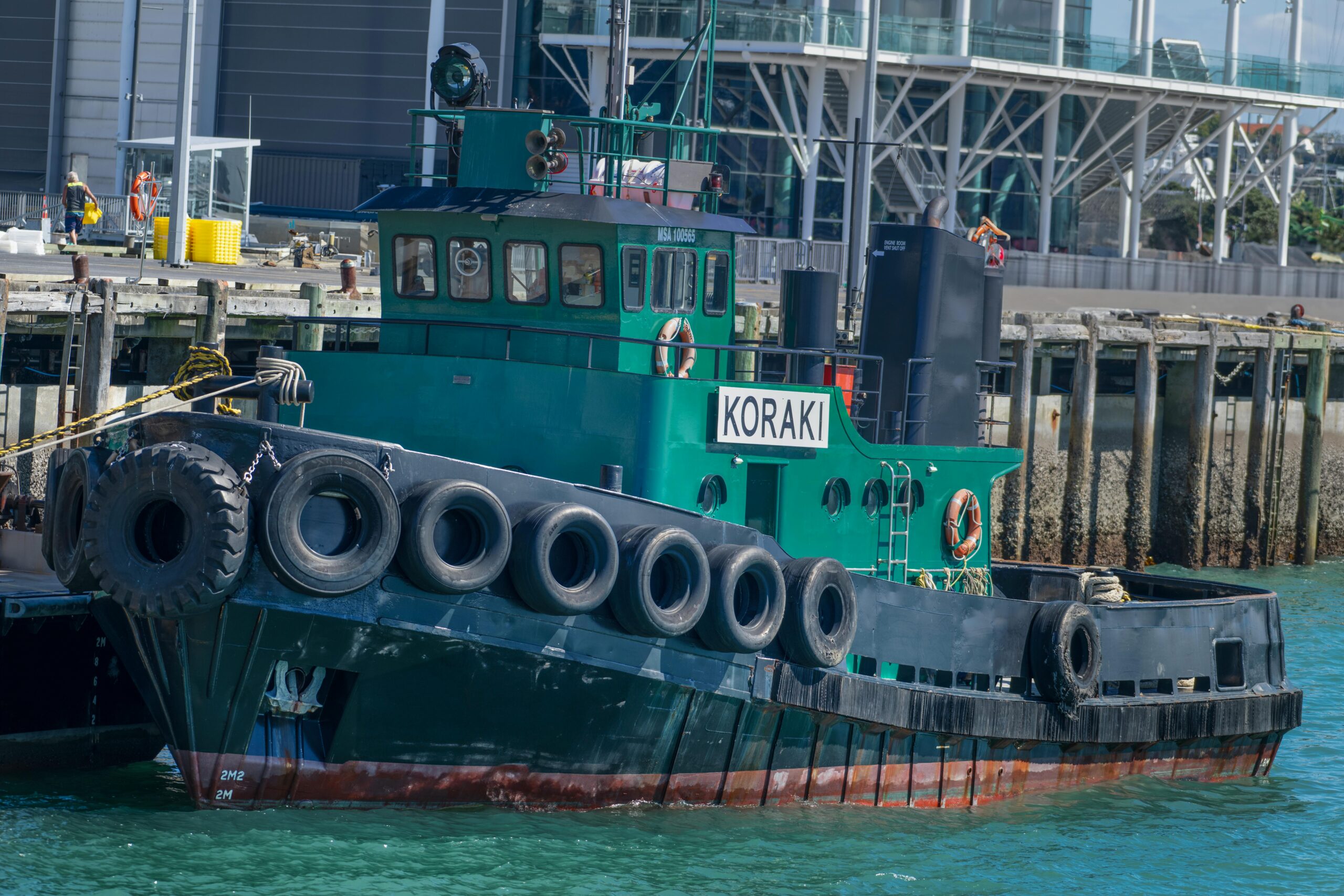 the koraki tugboat docked at auckland port, perfect for maritime and nautical themes.