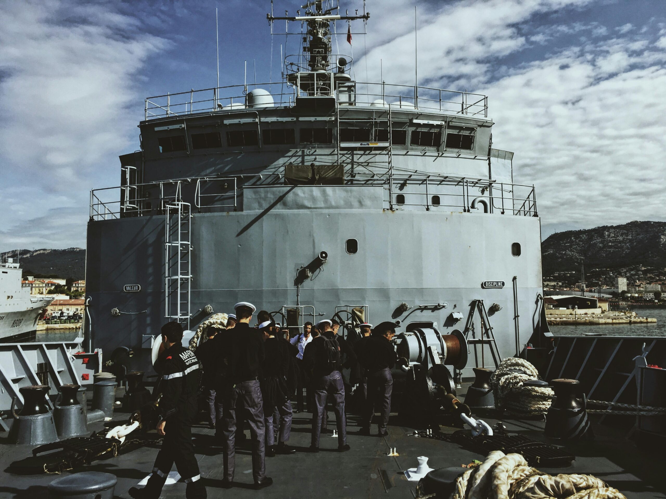 a navy crew gathered on a ship's deck in toulon, provence-alpes-côte d'azur, france.