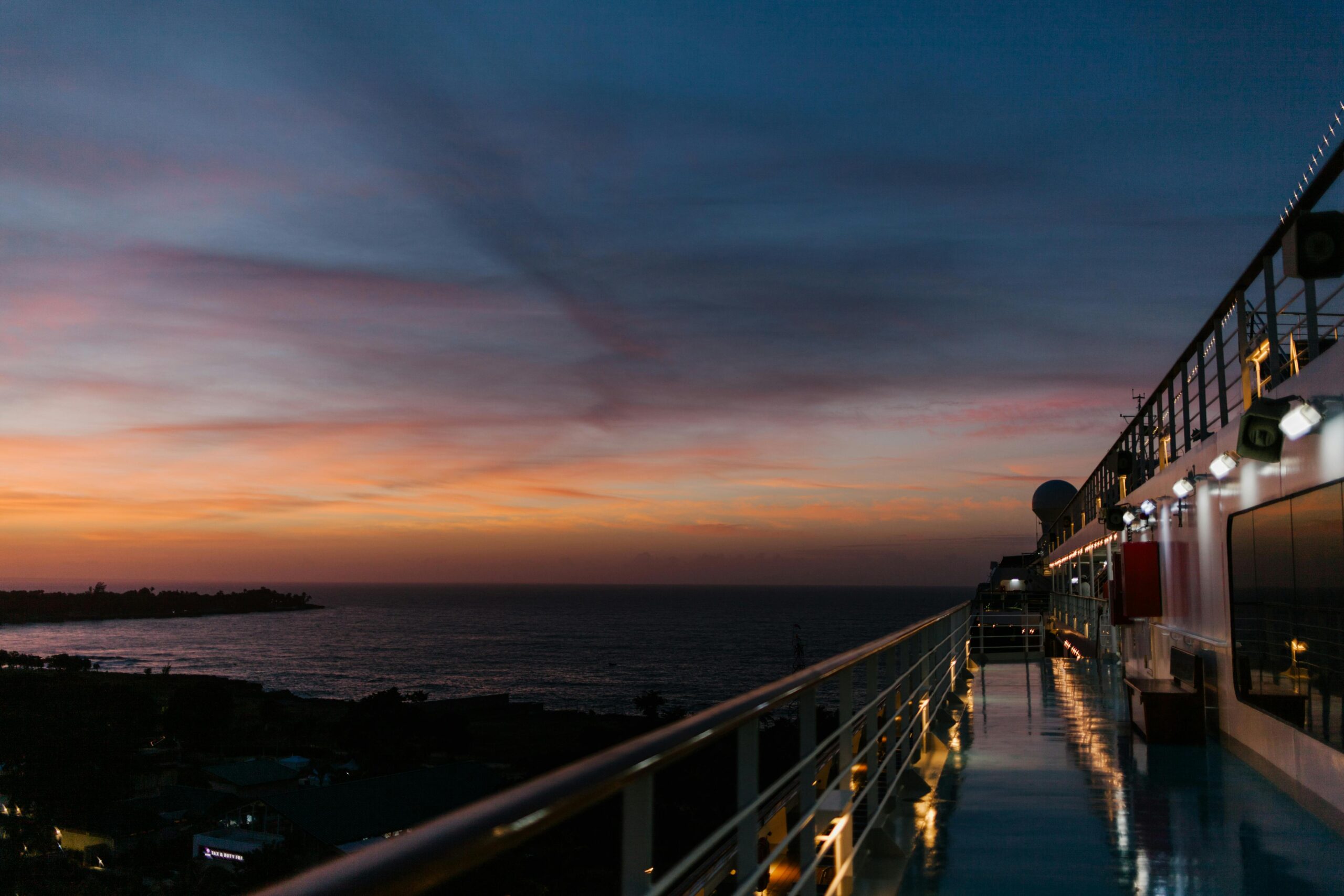 experience the tranquil beauty of twilight from a cruise ship deck, overlooking a serene ocean sunset.