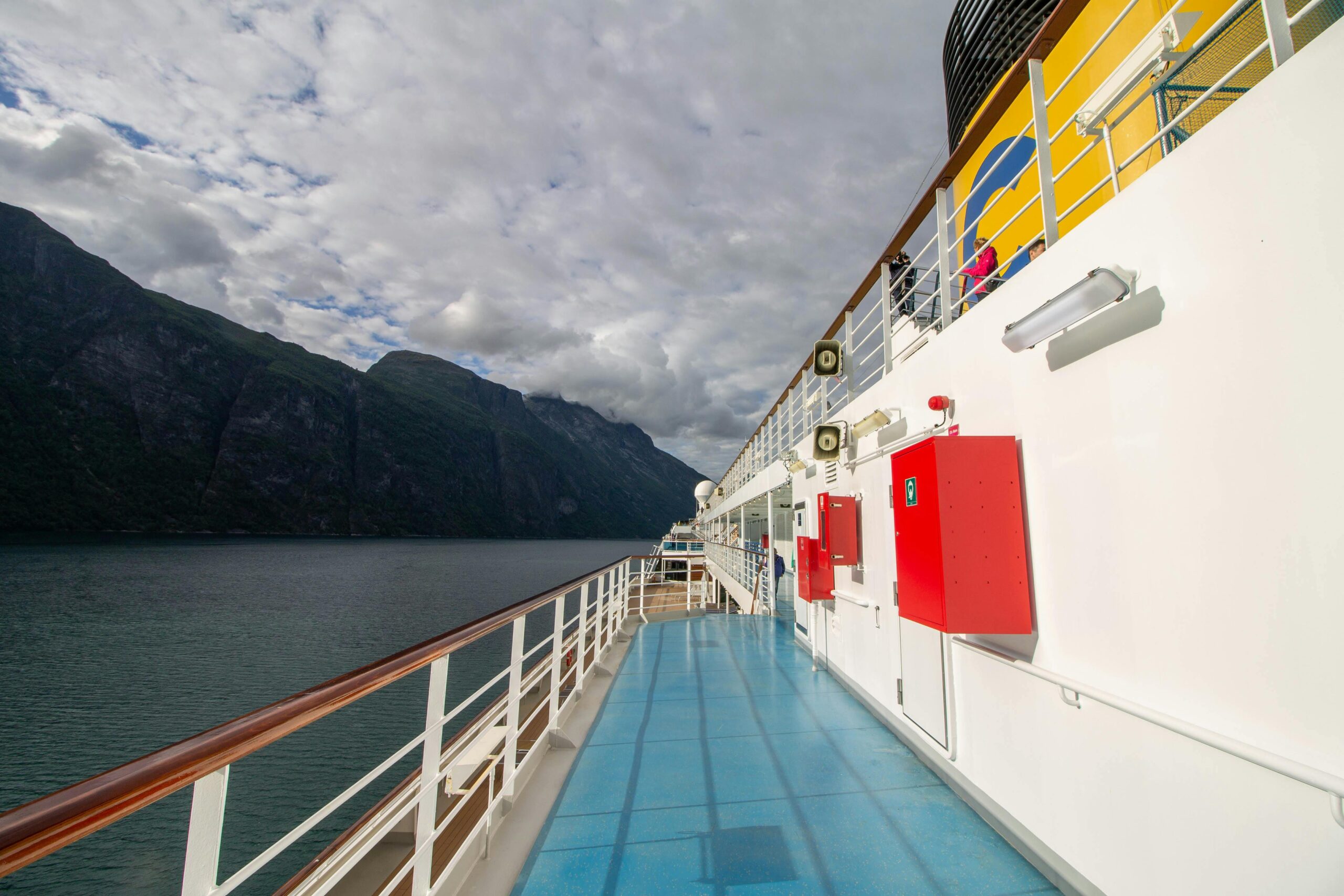 explore a cruise ship deck with breathtaking fjord views, perfect for travel enthusiasts.