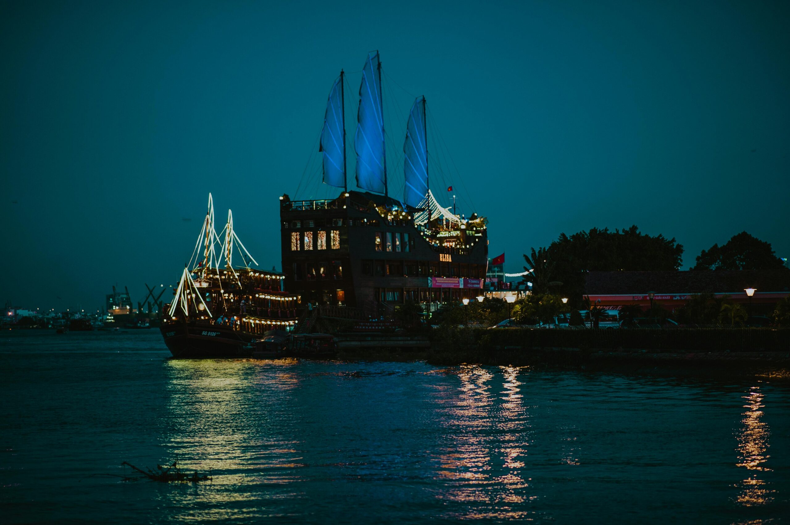 a serene harbor at night with an illuminated ship reflecting on calm waters. perfect for travel or maritime themes.