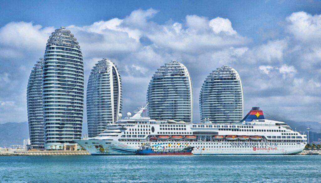 a modern city skyline with a cruise ship docked at the harbor.