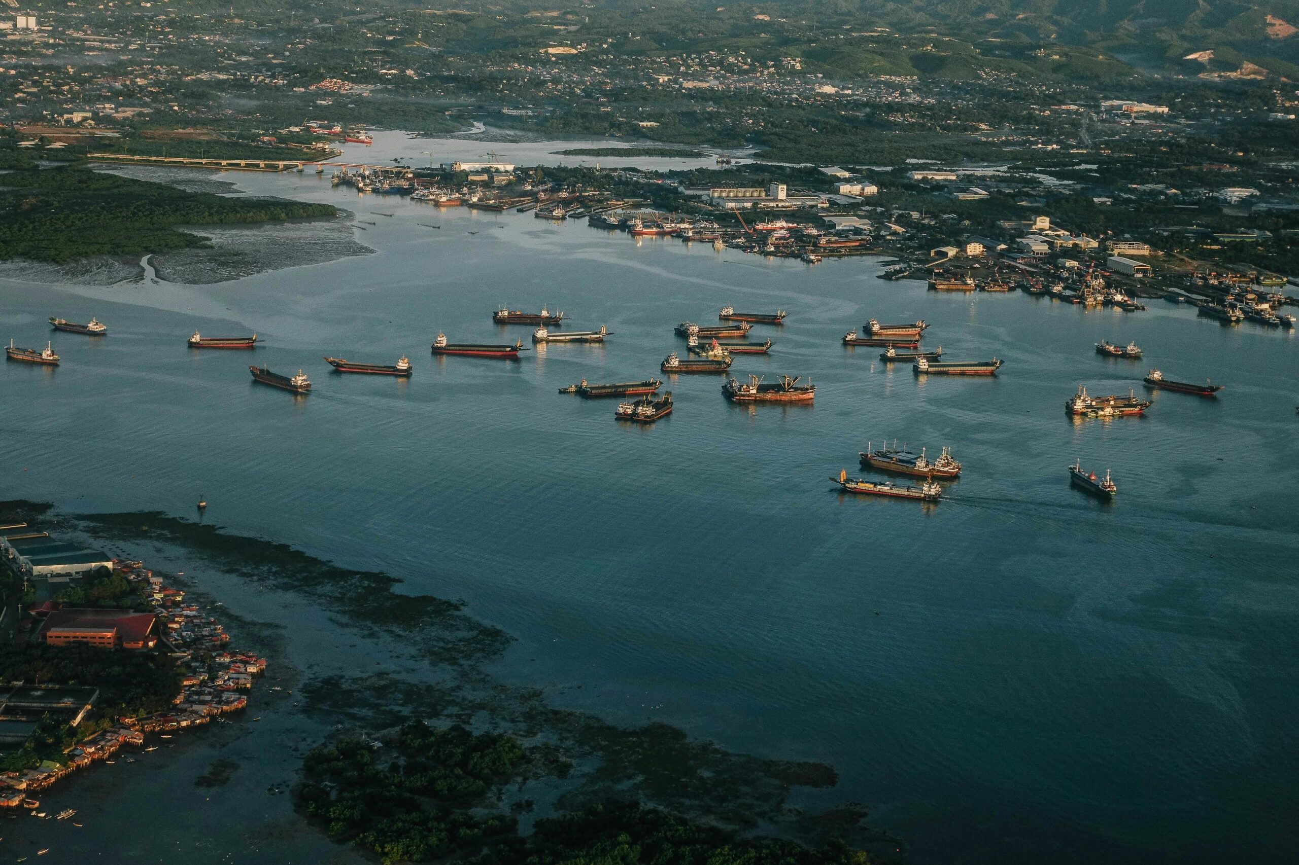 a striking aerial capture of numerous ships in a busy harbor under daylight, showcasing maritime activity.