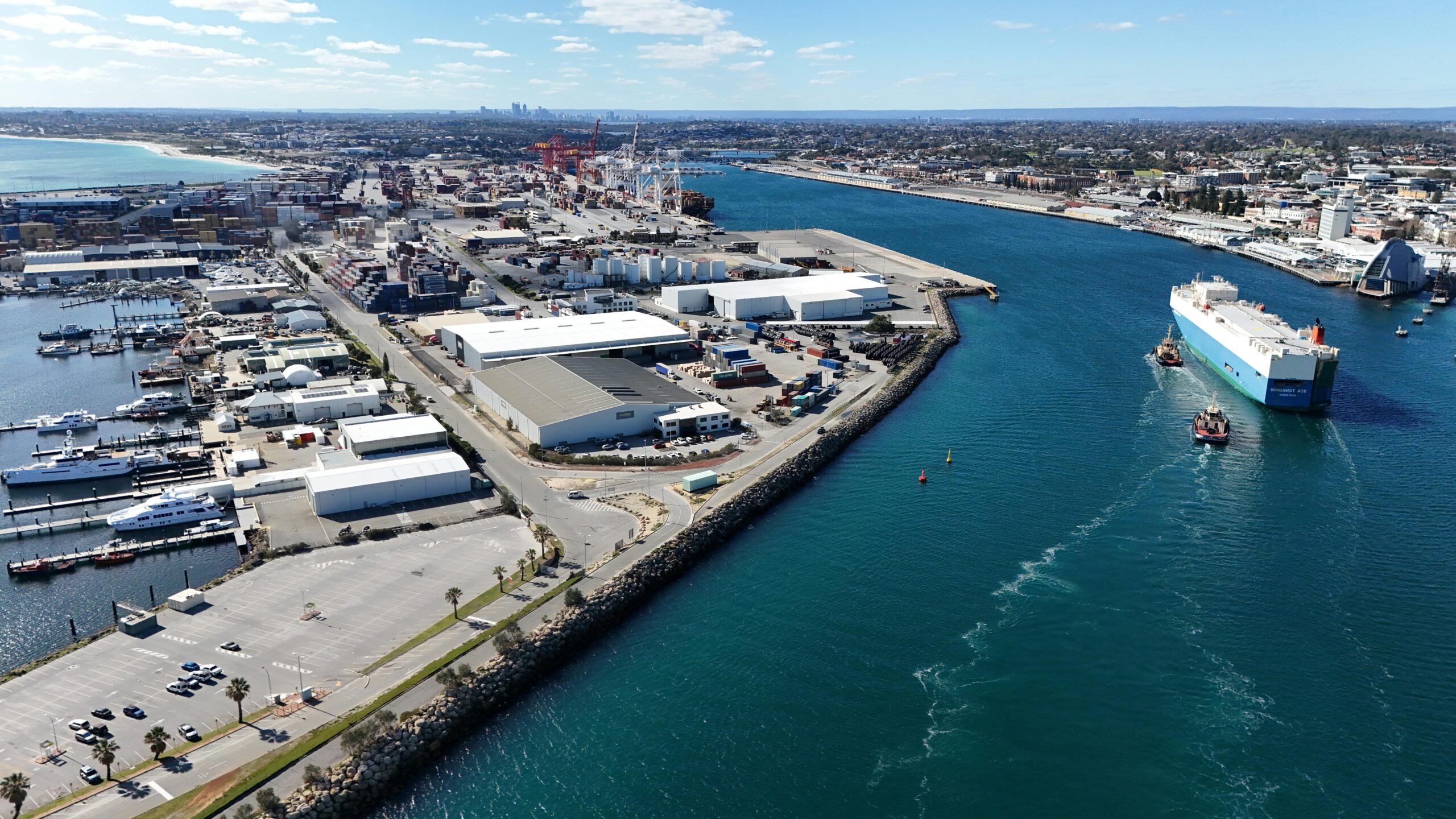 aerial shot of fremantle port in western australia, showcasing container ships and industrial landscape.