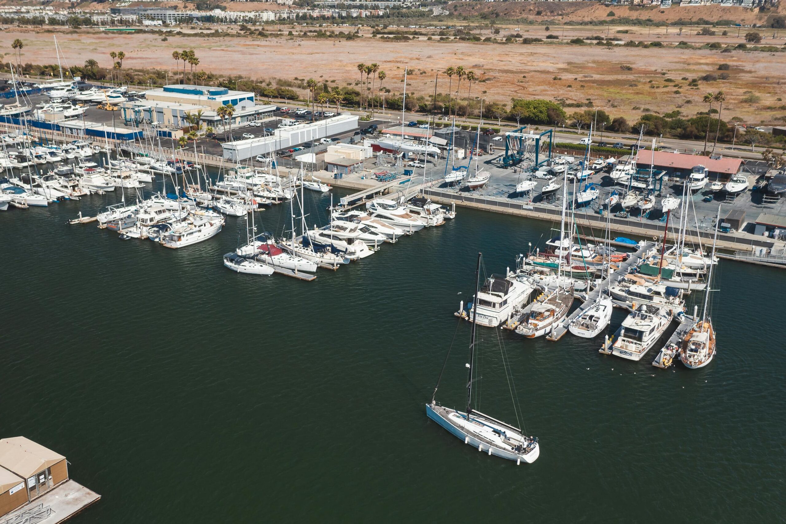 aerial shot of a marina in california with numerous boats docked, showcasing travel and leisure.
