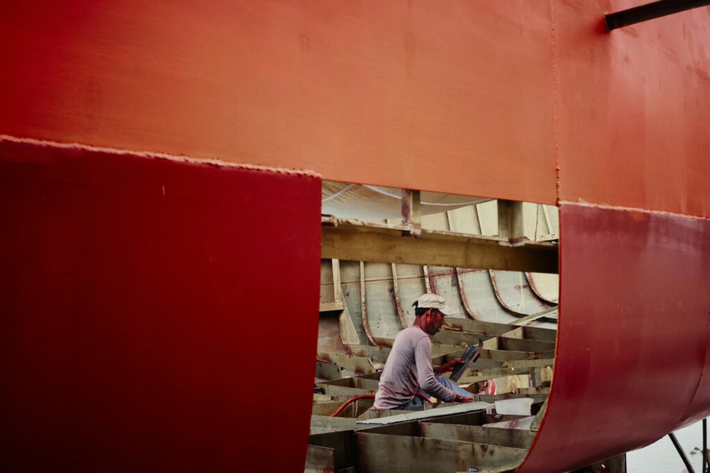 shipyard worker welding structure of ship in chilmari, bangladesh. captured in action.
