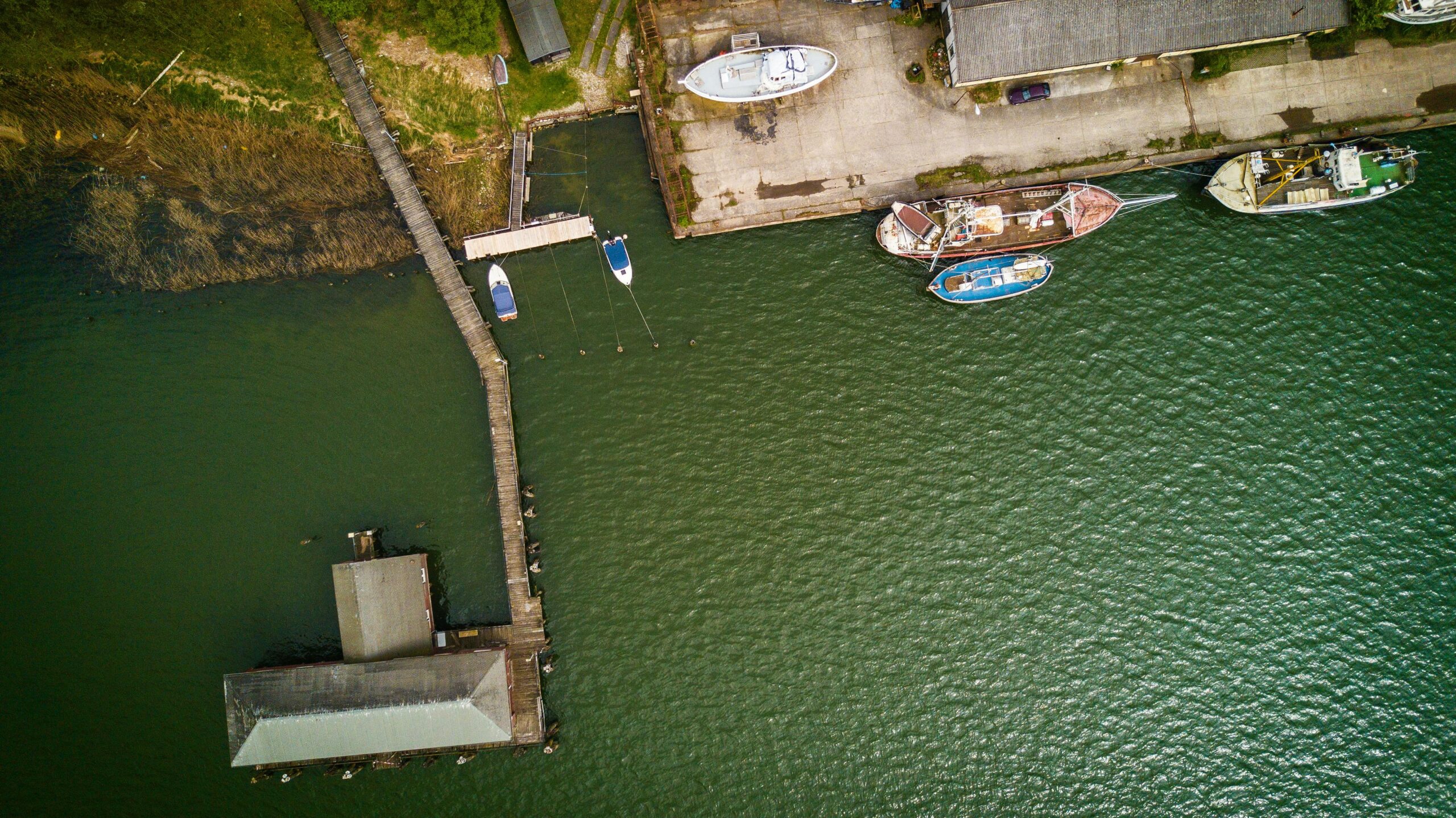 aerial photograph of boats docked at stralsund harbor, showcasing nautical architecture and water reflections.