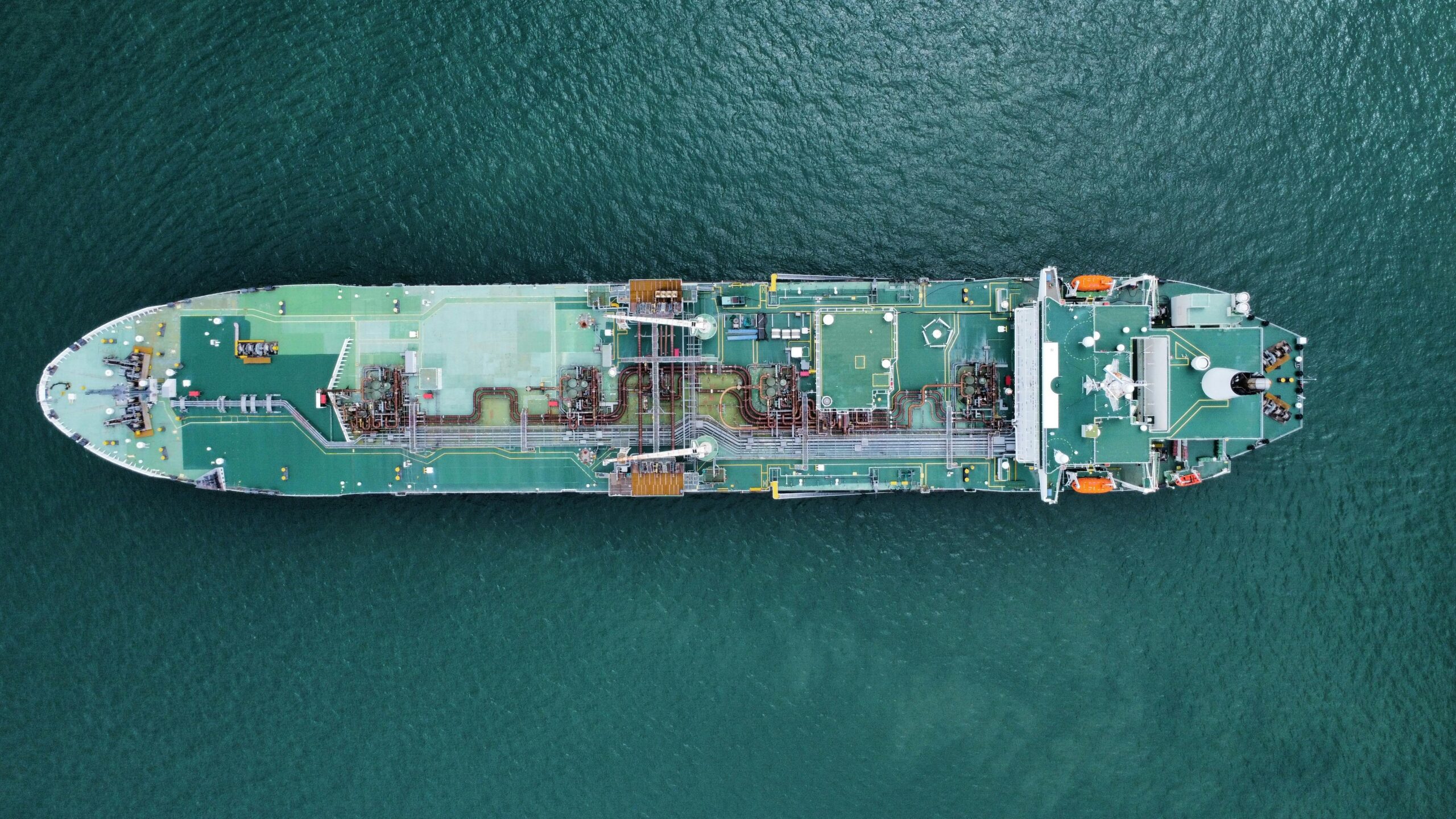 aerial shot of a large tanker ship in calm ocean waters, showcasing its structure and design.